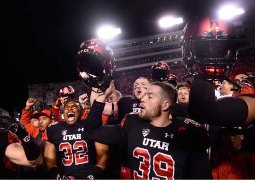 Scott Sommerdorf   |  The Salt Lake Tribune
Utah Utes LB Sharrieff Shah Jr. (32) and Utah Utes PK Andy Phillips (39) along with the rest of the team sing "Utah Man" after the game. Utah defeated Arizona State 34-18, Saturday, October 17, 2015.