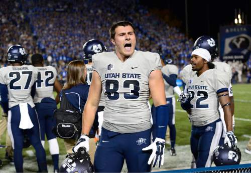 Scott Sommerdorf  |  The Salt Lake Tribune
Utah State Aggies tight end Wyatt Houston (83) yells to the BYU crowd after a USU TD made the score 21-14 late in the first half. Utah State led BYU 28-14 at the half in Provo, Friday, October 1, 2014.