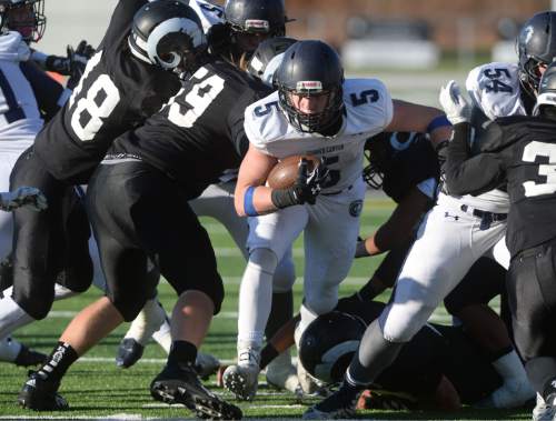 Steve Griffin  |  The Salt Lake Tribune

Corner Canyon Tyler Critchfield breaks through the Highland line during the Class 4A quarterfinal football game at Highland High School in Salt Lake City, Friday, November 6, 2015.