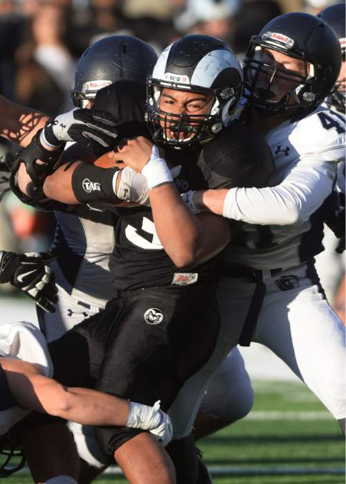 Steve Griffin  |  The Salt Lake Tribune

Highland Talo Latu gets swallowed up by the Corner Canyon defense during the Class 4A quarterfinal football game at Highland High School in Salt Lake City, Friday, November 6, 2015.