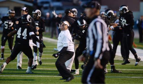 Steve Griffin  |  The Salt Lake Tribune

Highland players and coaches explode off the sidelines after Nathan Roderick intercepting a Corner Canyon pass in the second overtime of a wild finish in the Class 4A quarterfinal football game against Corner Canyon at Highland High School in Salt Lake City, Friday, November 6, 2015.  Highland scored 21 points in the final 3 minutes of the game to tie Corner Canyon at 35 and went on to win in double overtime 41-38.