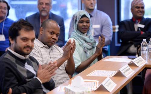 Al Hartmann  |  The Salt Lake Tribune
Refugee leaders applaud as Gov. Gary Herbert and officials are introduced in a roundtable meeting with area refugees at the new Utah Refugee Education and Training Center at Salt Lake Communty College Medowbrook Campus Tuesday Nov 10.