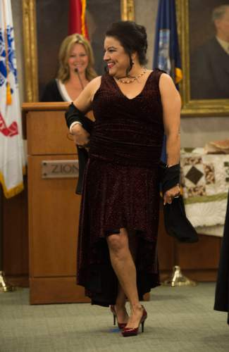 Steve Griffin  |  The Salt Lake Tribune

Kelly Holmes, who was a sergeant first class in the Army, models her gown during the "Grit to Glamour" fashion show at the Zions Bank offices in Salt Lake City, Tuesday, November 10, 2015.  As part of the evening women military veterans traded camouflage and boots as they modeled gowns and heels.