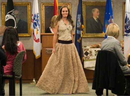 Steve Griffin  |  The Salt Lake Tribune

Emery Blanchard, technical sergeant in the Air Force, models her gown during the "Grit to Glamour" fashion show at the Zions Bank offices in Salt Lake City, Tuesday, November 10, 2015.  As part of the evening women military veterans traded camouflage and boots as they modeled gowns and heels.