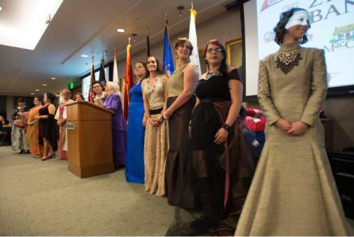 Steve Griffin  |  The Salt Lake Tribune

Women veterans stand after modeling gowns media specially for them during the ìGrit to Glamourî fashion show at the Zions Bank offices in Salt Lake City, Tuesday, November 10, 2015.  As part of the evening women military veterans traded camouflage and boots as they modeled gowns and heels.