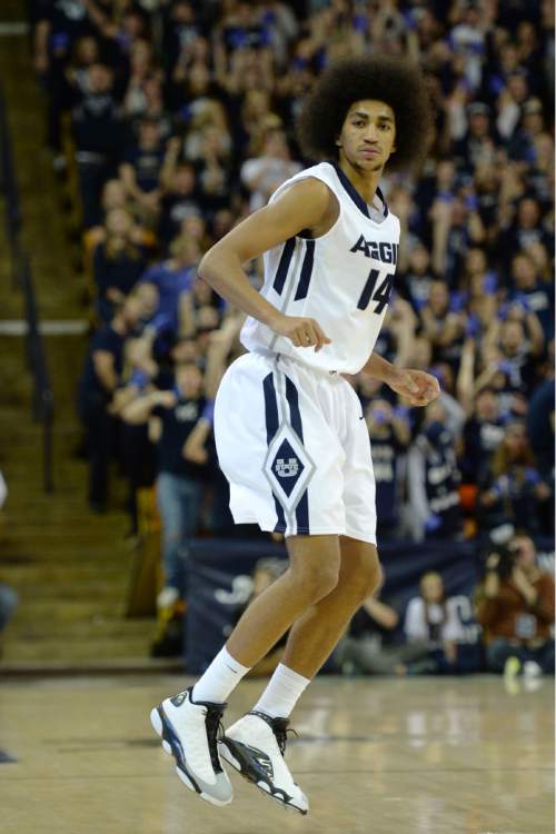 Steve Griffin  |  The Salt Lake Tribune

Utah State Aggies guard Jalen Moore (14) hops down the court after nailing a three-pointer during second half action in the BYU versus USU men's basketball game in Logan, Tuesday, December 2, 2014.