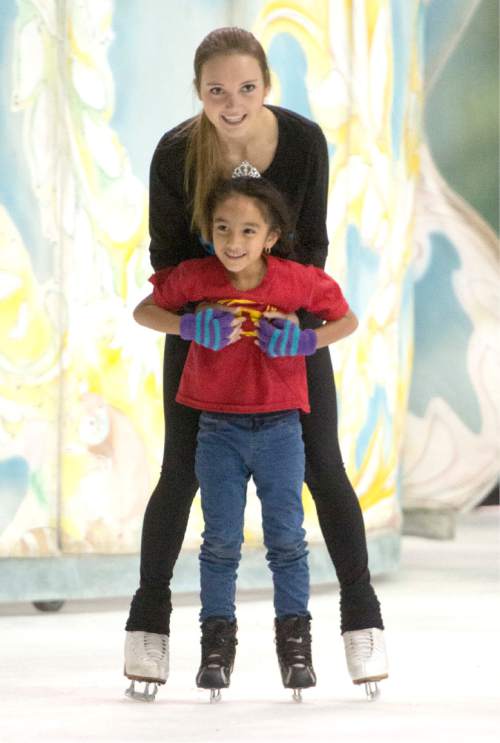Rick Egan  |  The Salt Lake Tribune

Kasey Miranda, 6, skates with Elena Ban Aert. Children from local charities skated with cast members of Disney on Ice's "Dare to Dream" show, at Vivint Smart Home Arena, Thursday, November 12, 2015.
