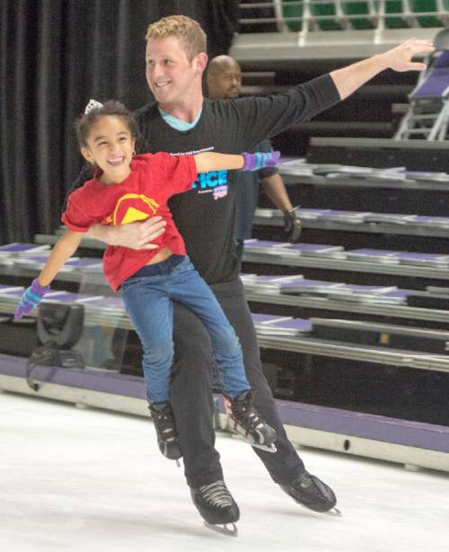 Rick Egan  |  The Salt Lake Tribune

Kasey Miranda, 6, skates with Nick Kelly, as children from local charities skated with cast members of Disney on Ice's "Dare to Dream" show, at Vivint Smart Home Arena, Thursday, November 12, 2015.