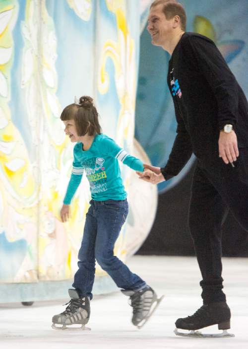 Rick Egan  |  The Salt Lake Tribune

Brianna Hunt 7, skates with Vladimir Sadornee, as children from local charities skated with cast members of Disney on Ice's "Dare to Dream" show, at Vivint Smart Home Arena, Thursday, November 12, 2015.