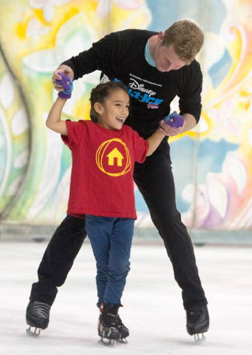Rick Egan  |  The Salt Lake Tribune

Kasey Miranda, 6, skates with Nick Kelly, as children from local charities skated with cast members of Disney on Ice's "Dare to Dream" show, at Vivint Smart Home Arena, Thursday, November 12, 2015.