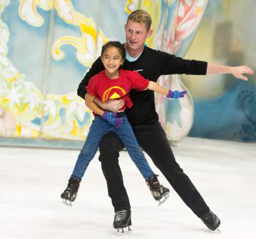 Rick Egan  |  The Salt Lake Tribune
Kasey Miranda, 6, skates with Nick Kelly, as children from local charities skated with cast members of Disney on Ice's "Dare to Dream" show, at Vivint Smart Home Arena, Thursday, November 12, 2015.