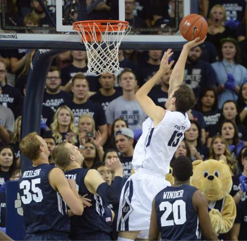 Steve Griffin  |  The Salt Lake Tribune

Utah State Aggies forward David Collette (13) shoots over the BYU defense during first half action in the BYU versus USU men's basketball game in Logan, Tuesday, December 2, 2014.