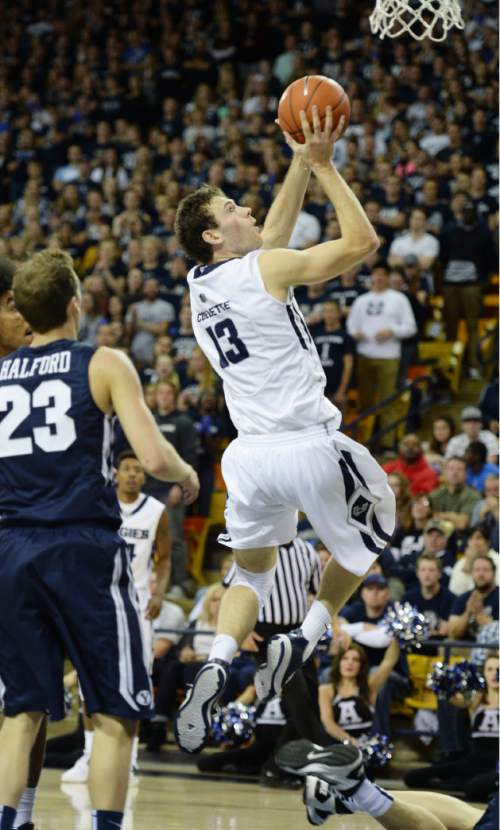 Steve Griffin  |  The Salt Lake Tribune

Utah State Aggies forward David Collette (13) spins to the the basket during second half action in the BYU versus USU men's basketball game in Logan, Tuesday, December 2, 2014.