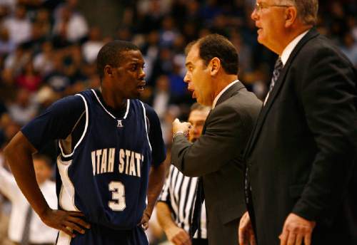 Djamila Grossman  |  The Salt Lake Tribune

Utah State University's coach Tim Duryea talks to Brockeith Pane, 3, at a game against Brigham Young University in Provo, Thursday, Nov. 17, 2010. BYU won the game.