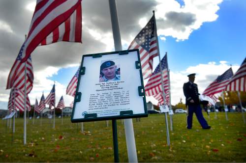 Scott Sommerdorf   |  The Salt Lake Tribune
A large field full of flags commemorating local veterans was on display at the end point of the Taylorsville Veteran's Day Parade, Wednesday, November 11, 2015.