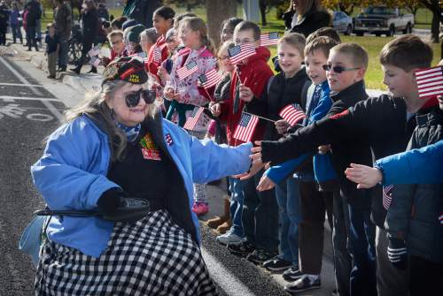 Scott Sommerdorf   |  The Salt Lake Tribune
Korean Veteran Wendy Griffin gets hand slaps from Bennion Elementary fifth graders during the Taylorsville Veteran's Day Parade, Wednesday, November 11, 2015.