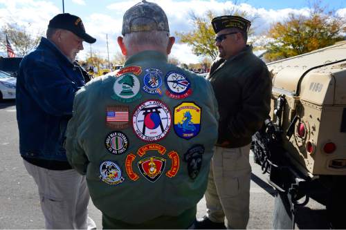 Scott Sommerdorf   |  The Salt Lake Tribune
Viet Nam veteran Bud Carraway wore a jacket with patches that represented family members who have served. He was waiting for the Taylorsville Veteran's Day Parade to begin, Wednesday, November 11, 2015.