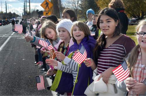 Scott Sommerdorf   |  The Salt Lake Tribune
Fifth graders from Bennion Elementary School cheer as the Taylorsville Veteran's Day Parade passes, Wednesday, November 11, 2015.