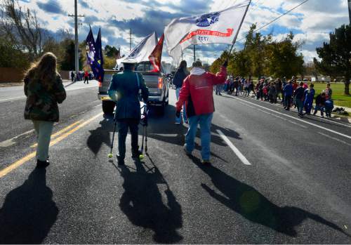 Scott Sommerdorf   |  The Salt Lake Tribune
Viet Nam veteran Phillip Gonzalez marches with his walker in the Taylorsville Veteran's Day Parade, Wednesday, November 11, 2015.