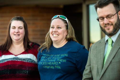 Chris Detrick  |  The Salt Lake Tribune
April Hoagland, Beckie Peirce and their attorney Jim Hunnicutt, smile during a press conference outside of the Juvenile Court in Price, Utah Friday November 13, 2015. Seventh District Juvenile Judge Scott Johansen has amended an order to remove a 9-month-old girl from the Price home of her same-sex foster parents and has instead scheduled a hearing on the matter.