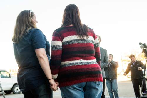 Chris Detrick  |  The Salt Lake Tribune
April Hoagland and Beckie Peirce hold hands during a press conference outside of the Juvenile Court in Price, Utah Friday November 13, 2015. Seventh District Juvenile Judge Scott Johansen has amended an order to remove a 9-month-old girl from the Price home of her same-sex foster parents and has instead scheduled a hearing on the matter.