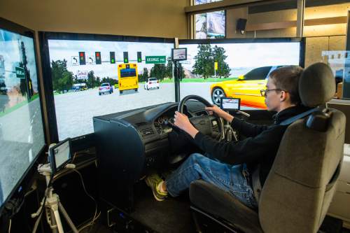 Chris Detrick  |  The Salt Lake Tribune
Alta High School freshman Keenan Davis tries out the driving simulator in the Utah Traffic Lab during the University of Utah College of Engineering's annual Engineering Day Saturday November 14, 2015.