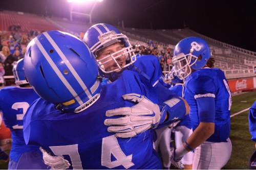 Leah Hogsten  |  The Salt Lake Tribune
Dixie's Hobbs Nyberg (9) celebrates the win with teammate Christian Stucki (74). Dixie High School football team leads Tooele High School 45-6 during their Class 3AA State Championship semifinal at Rice-Eccles Stadium, Friday, November 13, 2015.