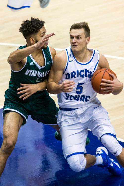 Chris Detrick  |  The Salt Lake Tribune
BYU guard Kyle Collinsworth (5) runs past UVU guard Telly Davenport (3) during the game at the Marriott Center Friday November 13, 2015.