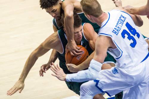 Chris Detrick  |  The Salt Lake Tribune
UVU forward Konner Frey (11) UVU guard Telly Davenport (3) and BYU forward Jakob Hartsock (34) go for a rebound during the game at the Marriott Center Friday November 13, 2015.