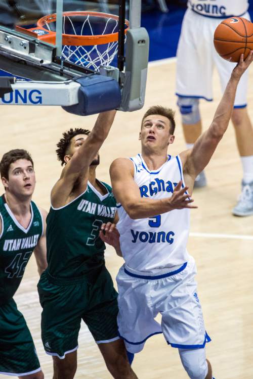 Chris Detrick  |  The Salt Lake Tribune
BYU guard Kyle Collinsworth (5) shoots past UVU guard Telly Davenport (3) during the game at the Marriott Center Friday November 13, 2015.