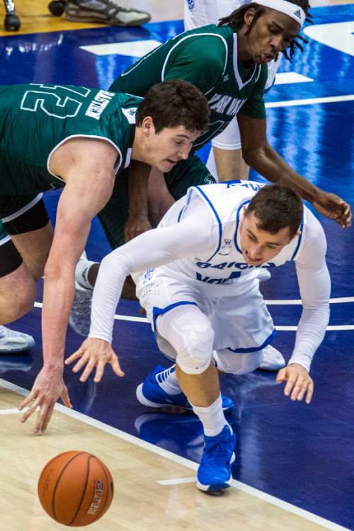 Chris Detrick  |  The Salt Lake Tribune
UVU center Andrew Bastien (42) BYU guard Nick Emery (4) and UVU guard Ivory Young (13) go for the ball during the game at the Marriott Center Friday November 13, 2015.