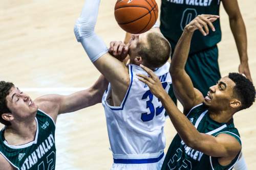 Chris Detrick  |  The Salt Lake Tribune
UVU center Andrew Bastien (42) BYU forward Nate Austin (33) and UVU forward Dayon Goodman (33) go for a rebound during the game at the Marriott Center Friday November 13, 2015.