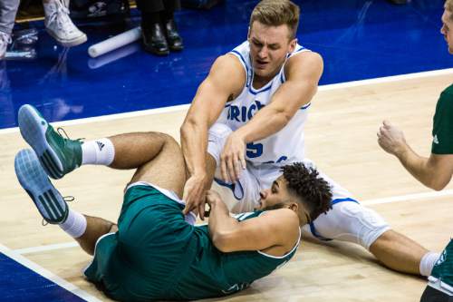 Chris Detrick  |  The Salt Lake Tribune
BYU guard Kyle Collinsworth (5) and UVU guard Telly Davenport (3) fight for a rebound during the game at the Marriott Center Friday November 13, 2015.