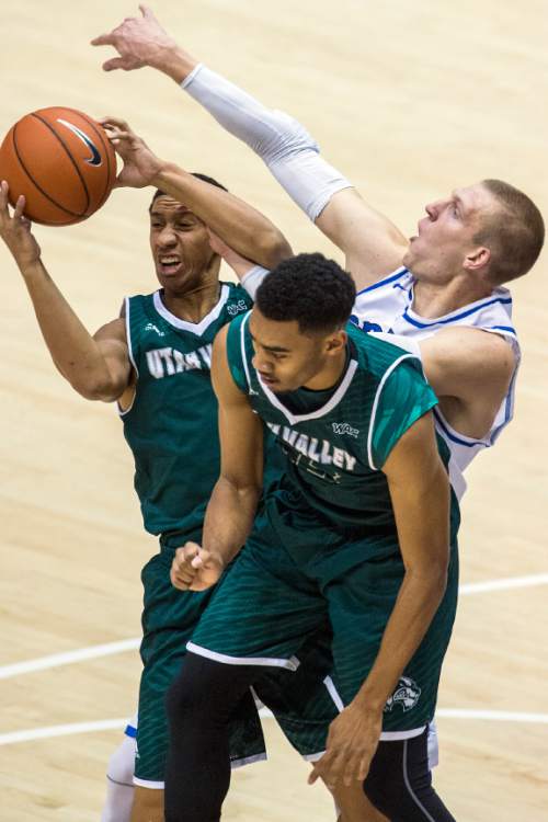 Chris Detrick  |  The Salt Lake Tribune
UVU guard Marcel Davis (0) UVU forward Dayon Goodman (33) and BYU forward Nate Austin (33) go for the ball during the game at the Marriott Center Friday November 13, 2015.