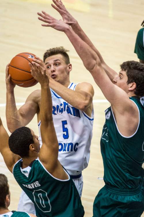 Chris Detrick  |  The Salt Lake Tribune
BYU guard Kyle Collinsworth (5) is guarded by UVU guard Marcel Davis (0) and UVU center Andrew Bastien (42) during the game at the Marriott Center Friday November 13, 2015.
