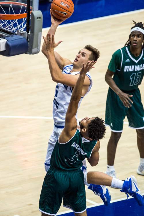 Chris Detrick  |  The Salt Lake Tribune
BYU guard Kyle Collinsworth (5) shoots past UVU guard Telly Davenport (3)during the game at the Marriott Center Friday November 13, 2015.