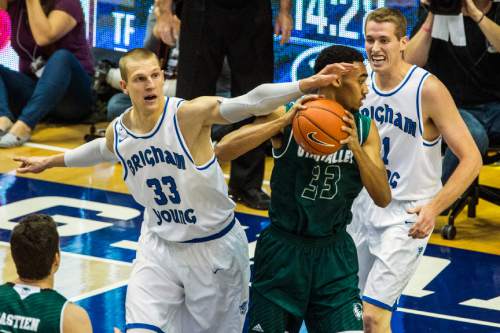 Chris Detrick  |  The Salt Lake Tribune
BYU forward Nate Austin (33) UVU forward Dayon Goodman (33) and BYU forward Kyle Davis (21) go for the ball during the game at the Marriott Center Friday November 13, 2015.