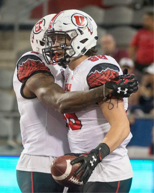 Rick Egan  |  The Salt Lake Tribune

 Utah Utes wide receiver Kenneth Scott (2) congratulates tight end Harrison Handley (88) celebrates after scoring a touchdown,  giving the Utes a 24-20 lead early in the second half,  in PAC-12 action against the Arizona Wildcats, in Tucson, Saturday, November 14, 2015.