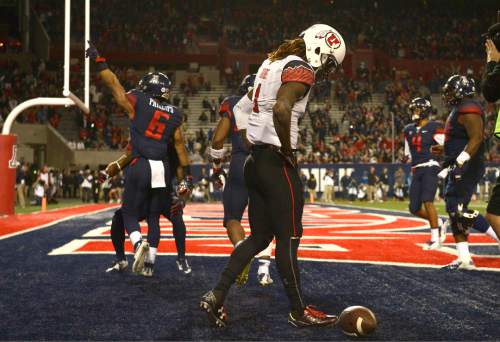 Rick Egan  |  The Salt Lake Tribune

Utah Utes wide receiver Kenneth Scott (2), hangs his head, as Arizona Wildcats Nate Phillips (6) celebrate the touchdown that eventually gave Arizona  their 37-30 win over the Utes in double overtime, in PAC-12 action against the Arizona Wildcats, in Tucson, Saturday, November 14, 2015.