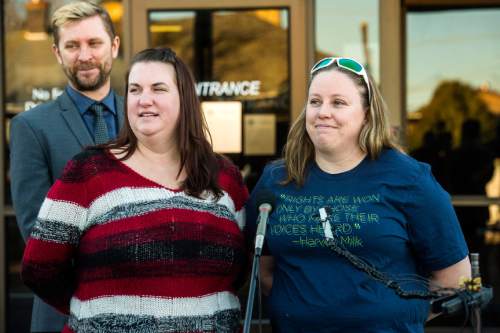 Chris Detrick  |  The Salt Lake Tribune
April Hoagland, Beckie Peirce and Equality Utah Executive Director Troy Williams smile during a press conference outside of the Juvenile Court in Price, Utah Friday November 13, 2015. Seventh District Juvenile Judge Scott Johansen has amended an order to remove a 9-month-old girl from the Price home of her same-sex foster parents and has instead scheduled a hearing on the matter.