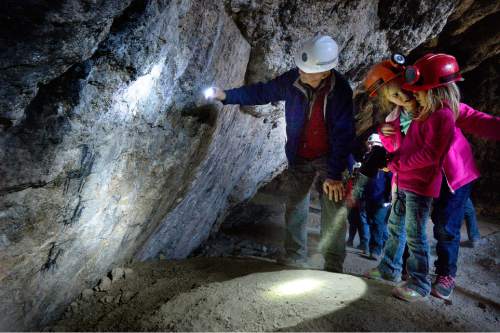 Scott Sommerdorf   |  The Salt Lake Tribune
Hikers examine ancient cave art in Danger Cave near Wendover on Saturday.
