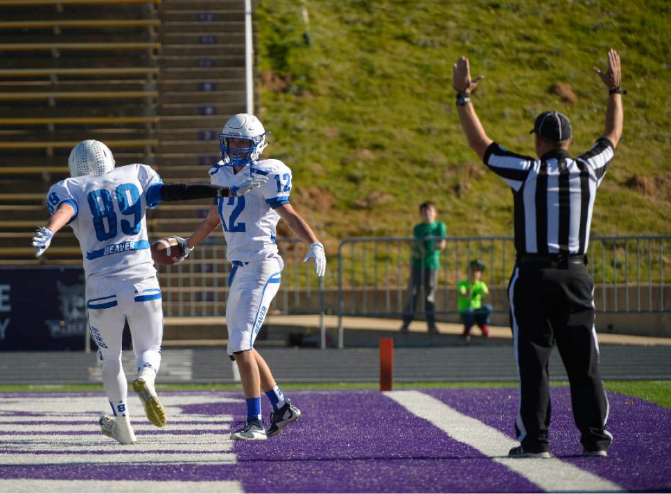 Leah Hogsten  |  The Salt Lake Tribune
Beaver's Brennon Hutchings (12) celebrates the touchdown with Brantson Blackburn (89). Beaver High School football team leads South Summit High School 33-0 during their Class 2A State Championship game at Wildcat Stadium in Ogden, Saturday, November 14, 2015.