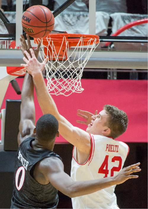Rick Egan  |  The Salt Lake Tribune

San Diego State Aztecs forward Skylar Spencer (0) takes the ball to the hoop, as Utah forward Jakob Poeltl (42) defends,  in basketball action, as the Utes defeated the San Diego State Aztecs 81-76, at the Huntsman Center, Tuesday, November 10, 2015.