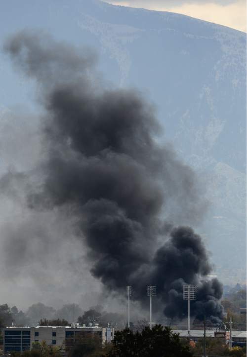 Francisco Kjolseth | The Salt Lake Tribune
Salt Lake City fire crews respond Wednesday afternoon to a 2-alarm structure fire at 1505 S. Main Street, sending black smoke into the sky that could be seen for miles around.
