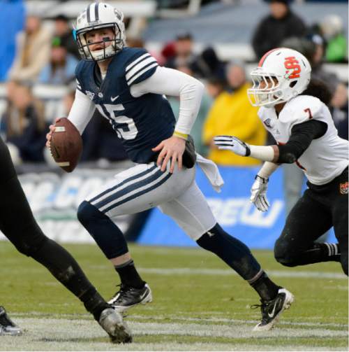 Trent Nelson  |   Tribune file photo
Brigham Young Cougars quarterback Ammon Olsen (15) scrambles as BYU hosts Idaho State, college football at LaVell Edwards Stadium in Provo, Saturday November 16, 2013.