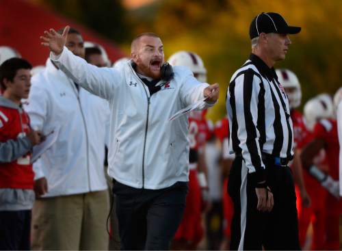 Scott Sommerdorf   |  The Salt Lake Tribune
East High coach Brandon Matich runs around an official to yell something to his defense during first half play. Valor Christian of Colorado beat East 26-10, Friday, September 18, 2015.