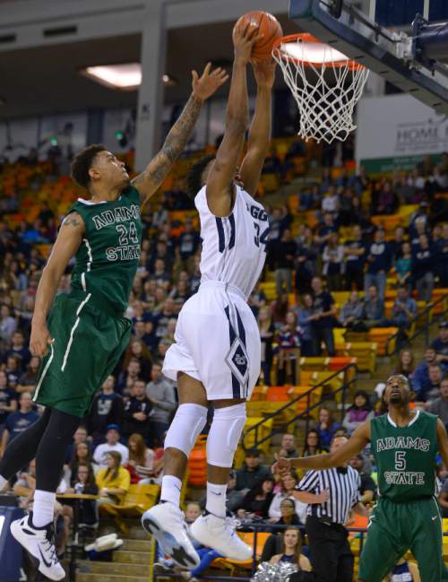 Leah Hogsten  |  The Salt Lake Tribune
Utah State Aggies guard Chris Smith (34) rounds Adams State Grizzlies forward Kendyl Grover (24) to hit the net. Utah State Aggies defeated Adams State Grizzlies, 83-68, Tuesday, November 17, 2015 at Smith Spectrum.