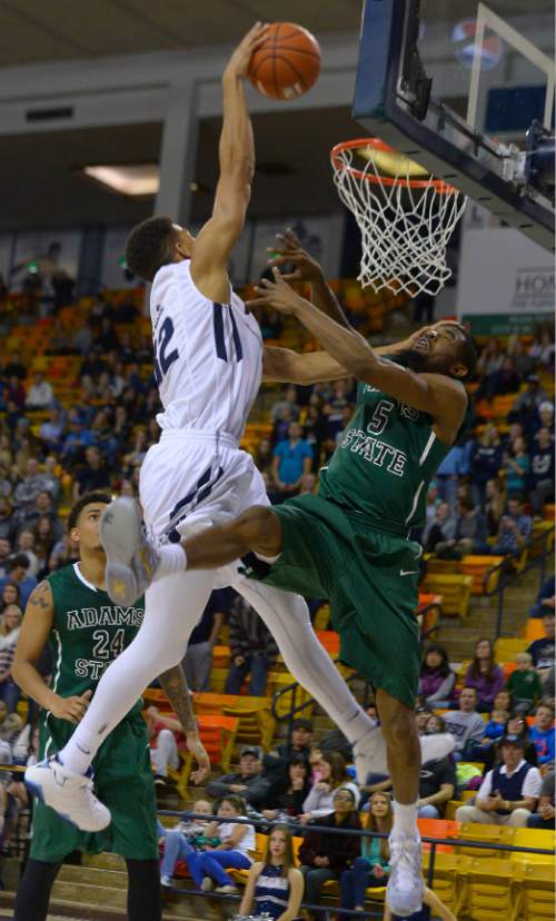 Leah Hogsten  |  The Salt Lake Tribune
Utah State Aggies forward Grayson Moore (32) is given a foul on Adams State Grizzlies guard Shakir Smith (5). Utah State Aggies defeated Adams State Grizzlies, 83-68, Tuesday, November 17, 2015 at Smith Spectrum.