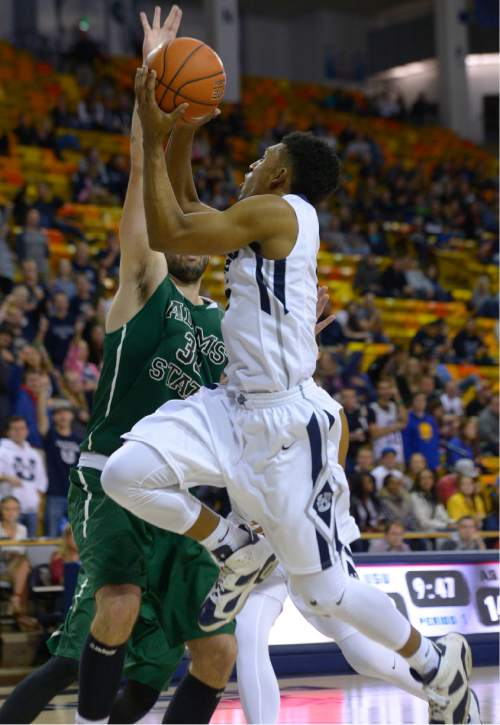 Leah Hogsten  |  The Salt Lake Tribune
Utah State Aggies guard Julion Pearre (5) skirts around Adam State Grizzlies forward Ante Mioc (33)Aggies leads Adams State Grizzlies, 47-27, Tuesday, November 17, 2015 at Smith Spectrum.
