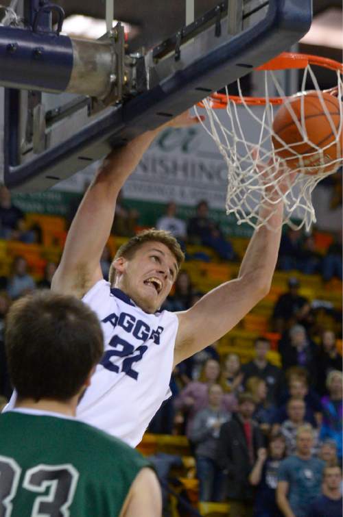 Leah Hogsten  |  The Salt Lake Tribune
Utah State Aggies forward Quinn Taylor (22) with the dunk. Utah State Aggies leads Adams State Grizzlies, 47-27, Tuesday, November 17, 2015 at Smith Spectrum.